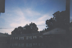 A photo of a picturesque sky near an apartment complex