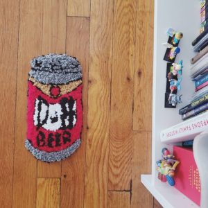 A tufted rug featuring a red beer can with "Duff" on it from the Simpsons.