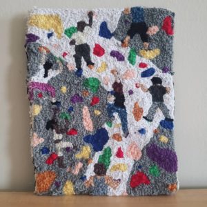 A tufted rug featuring people rock-climbing